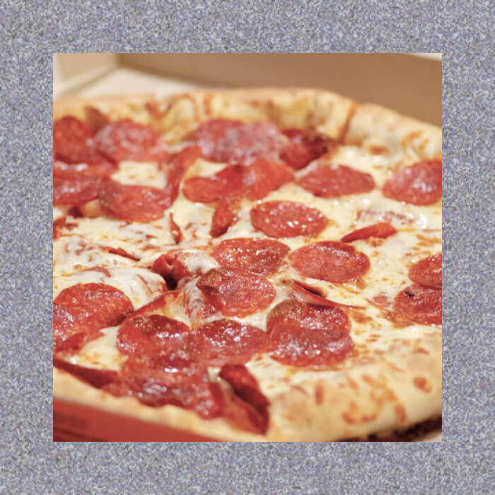 Sizzling pepperoni pizza sprinkled with melted cheese, perfectly presented in a square frame on a textured gray backdrop.