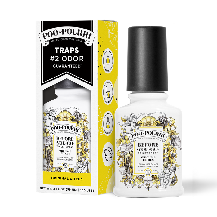 A ~Poo-Pourri “Before You Go” toilet spray in the Original Citrus scent is displayed alongside its packaging against a white background. The bottle features an ornate label with cherubs, toilet paper, and botanical elements. The packaging highlights key product benefits, including its ability to trap odors, the use of essential oils, and the absence of aerosols. The scent is described as a blend of lemon, bergamot, and lemongrass. The bottle contains 2 fl oz (59 ml) for up to 100 uses.