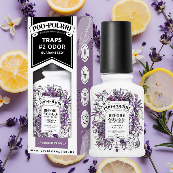A ~Poo-Pourri “Before You Go” toilet spray in the Lavender Vanilla scent is displayed alongside its packaging against a decorative purple background, featuring lemons and lavender. The bottle and box have an intricate design with cherubs, toilet paper, and lavender elements, highlighting the ingredients. The packaging emphasizes the product’s ability to trap odors before they start, with key details such as “100 Uses,” “No Aerosols,” and “Essential Oils” visible.