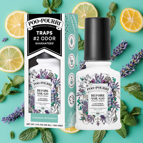 A ~Poo-Pourri “Before You Go” toilet spray in the Lavender Peppermint scent is displayed alongside its packaging against a decorative mint background, featuring lemons, peppermint, and peppermint. The bottle and box have an intricate design with cherubs, toilet paper, and citrus elements, highlighting the ingredients. The packaging emphasizes the product’s ability to trap odors before they start, with key details such as “100 Uses,” “No Aerosols,” and “Essential Oils” visible.