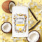 The Coconut Vanilla Sandalwood - Pit~Pourri Natural Deodorant from ~Pourri rests among coconut halves, vanilla pods, and white flowers on a bright yellow background. Infused with essential oils, it offers long-lasting freshness and is gentle on sensitive skin.