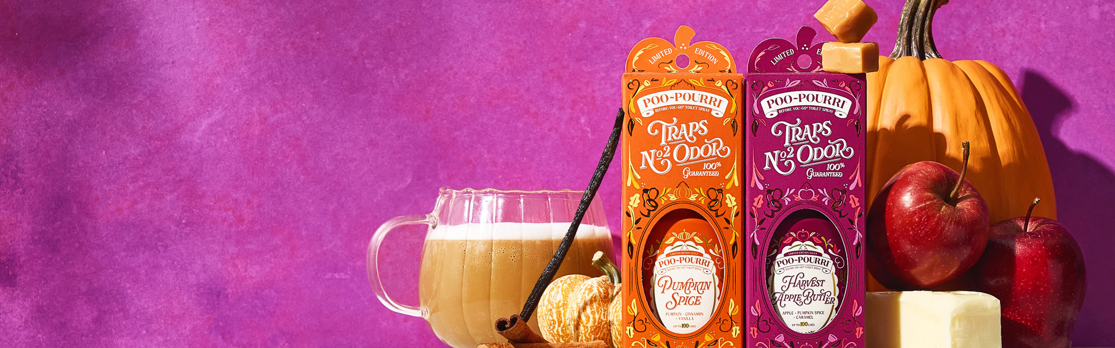 Two Poo~Pourri limited time fall scents next to a glass mug of iced pumpkin spice latte, vanilla, pumpkins, and apples set against a textured purple background.