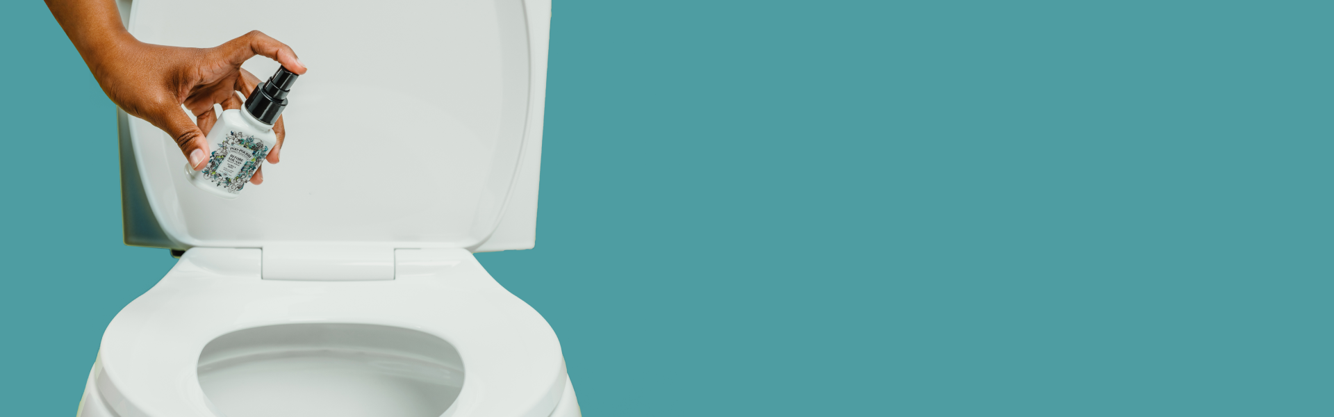 A hand holding a small spray bottle of Poo~Pourri Vanilla Mint toilet spray over an open white toilet seat, with a teal background.