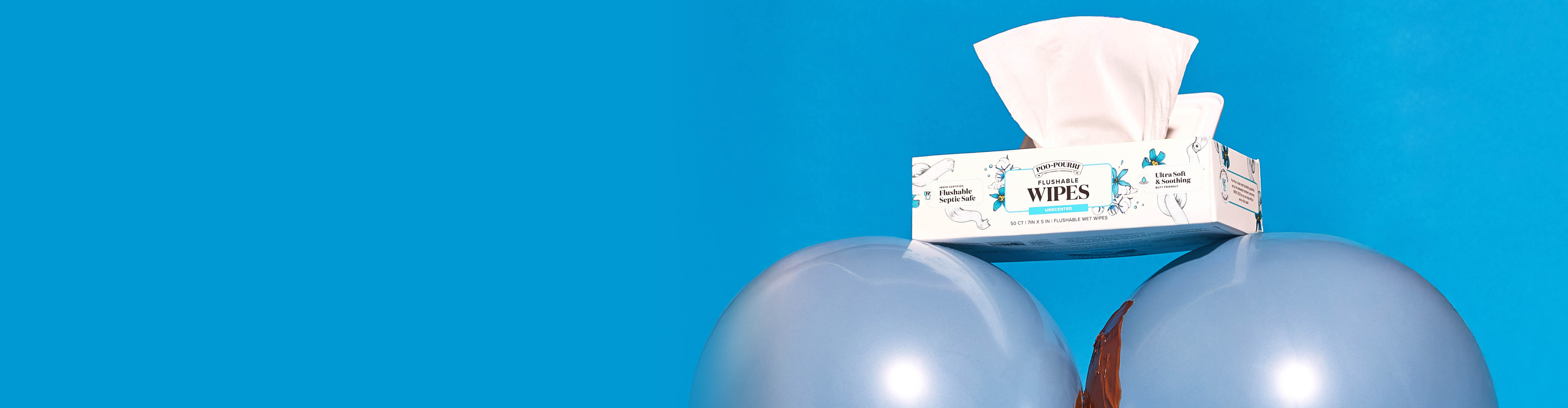 Box of Poo~Pourr flushable wipes on a blue background with balloons