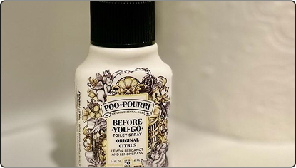 Bottle of Poo-Pourri Original citrus on a neutral background