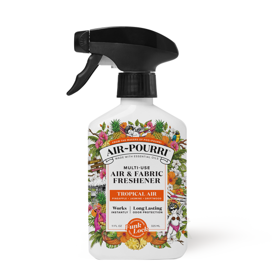 The ~Pourri Tropical Air - Home~Pourri Room Spray features a spray bottle with a pineapple and tropical plant design. Infused with essential oils, it offers a fresh and clean formula to freshen home odors.